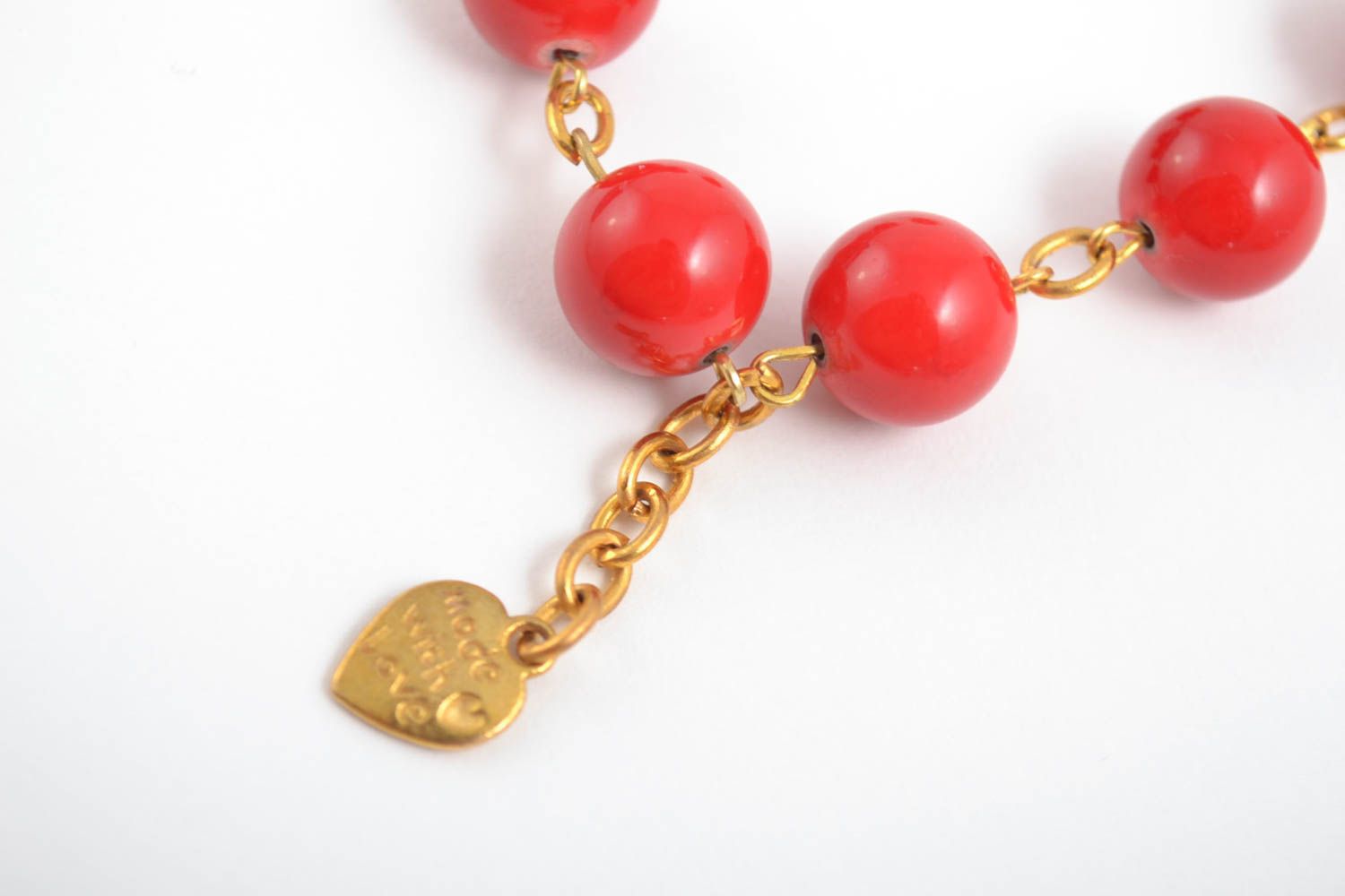 Red large beads bracelet on a chain in gold color with heart shape charm photo 3