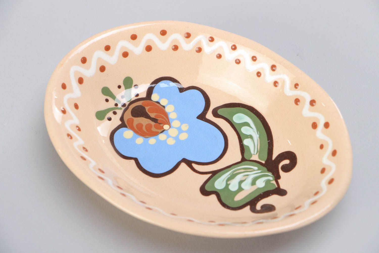 Light ceramic bowl with handmade floral painting with glaze in ethnic style  photo 3