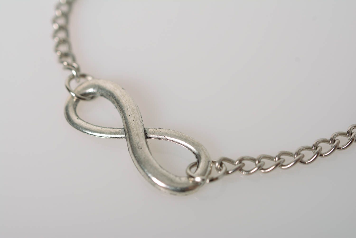 Handmade designer wrist bracelet with metal chain and infinity shaped insert photo 3