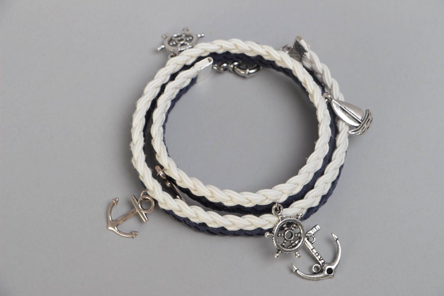 Handmade multi row wrist bracelet woven of suede cord in marine style with charm photo 2