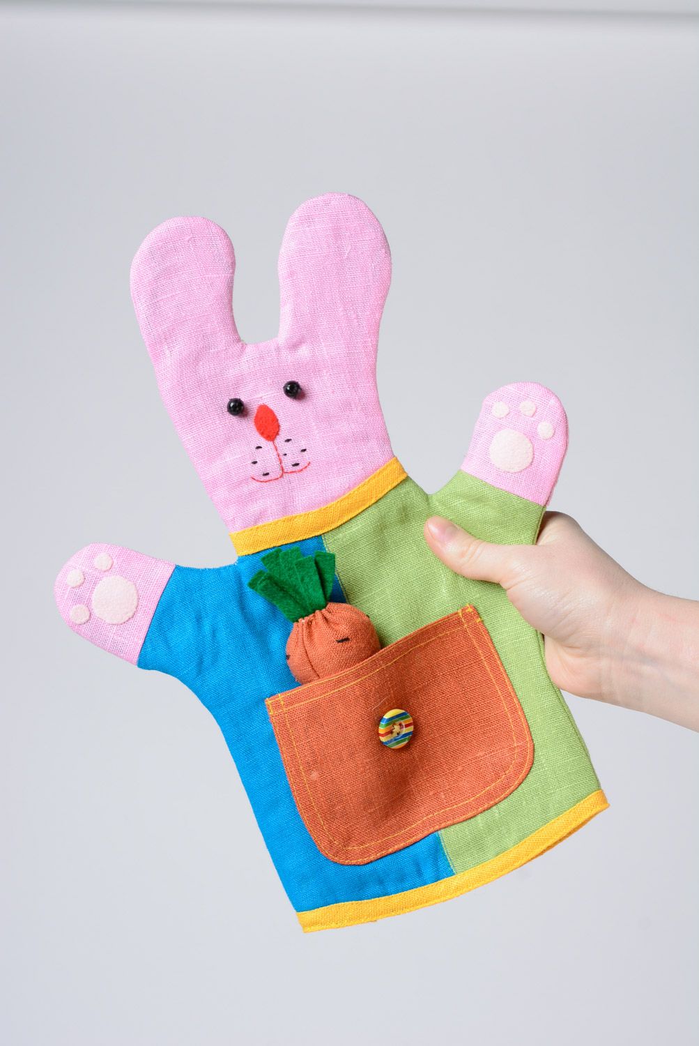 Bright colorful handmade hand puppet sewn of fabric pink rabbit photo 1