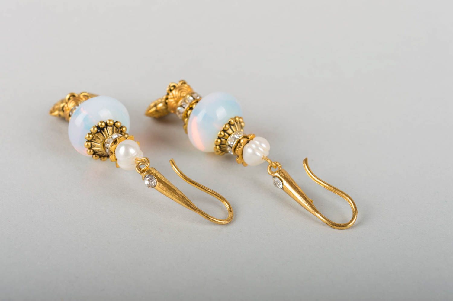 Beautiful female earrings with charms made of metal with pearls and moonstone photo 4