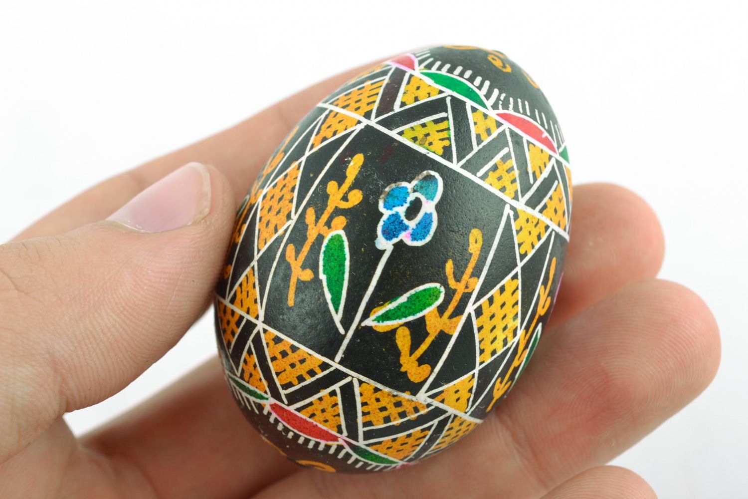 Colorful ornamented art Easter egg with handmade painting on black background photo 2
