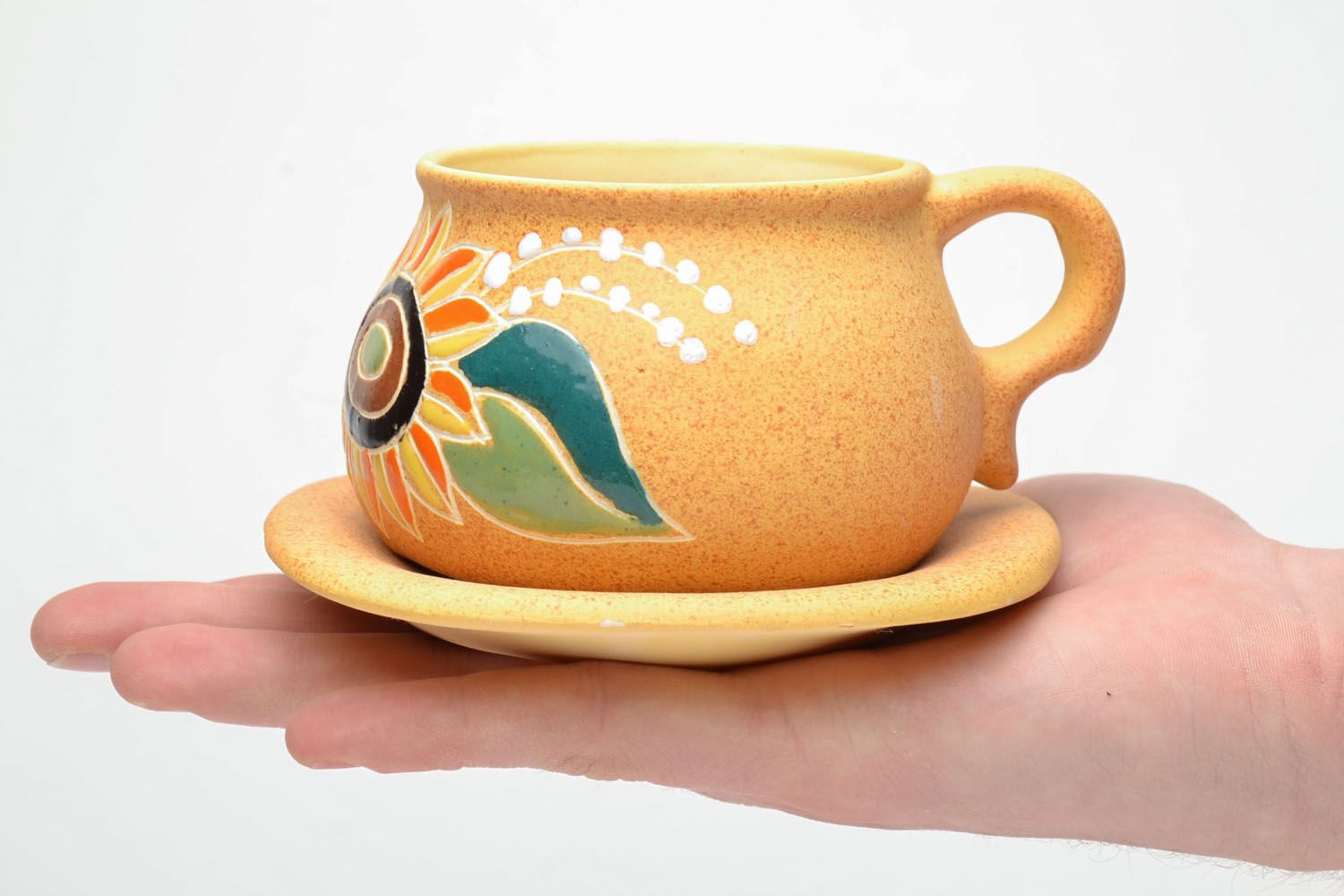 Art ceramic teacup with floral pattern in light yellow color with blue flower saucer and handle photo 5