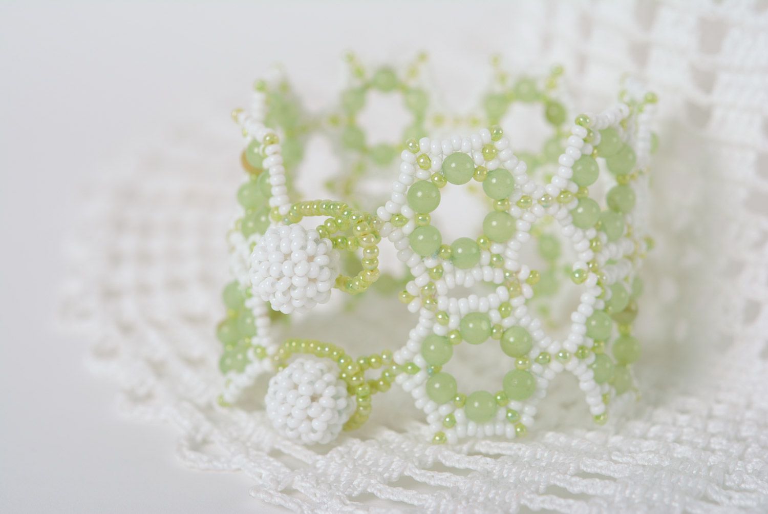 Tender wide handmade lacy wrist bracelet woven of white and light green beads photo 1