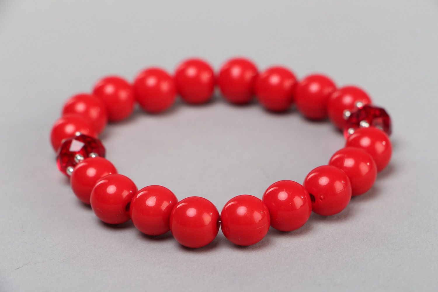 Handmade wrist bracelet with bright red plastic and glass beads for women photo 1