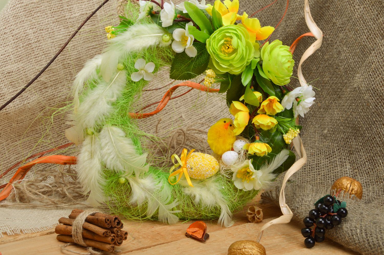 Handmade Easter wreath for home interior made of burlap with green feathers photo 1