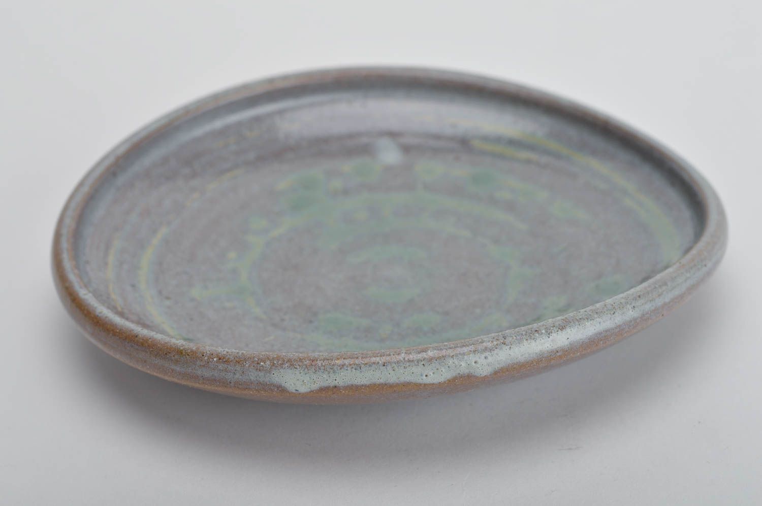 Handmade decorative round ceramic plate coated with glaze in blue green colors photo 2