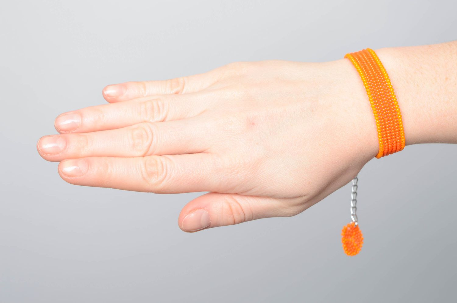 Orange handmade beaded bracelet with charm photo 3