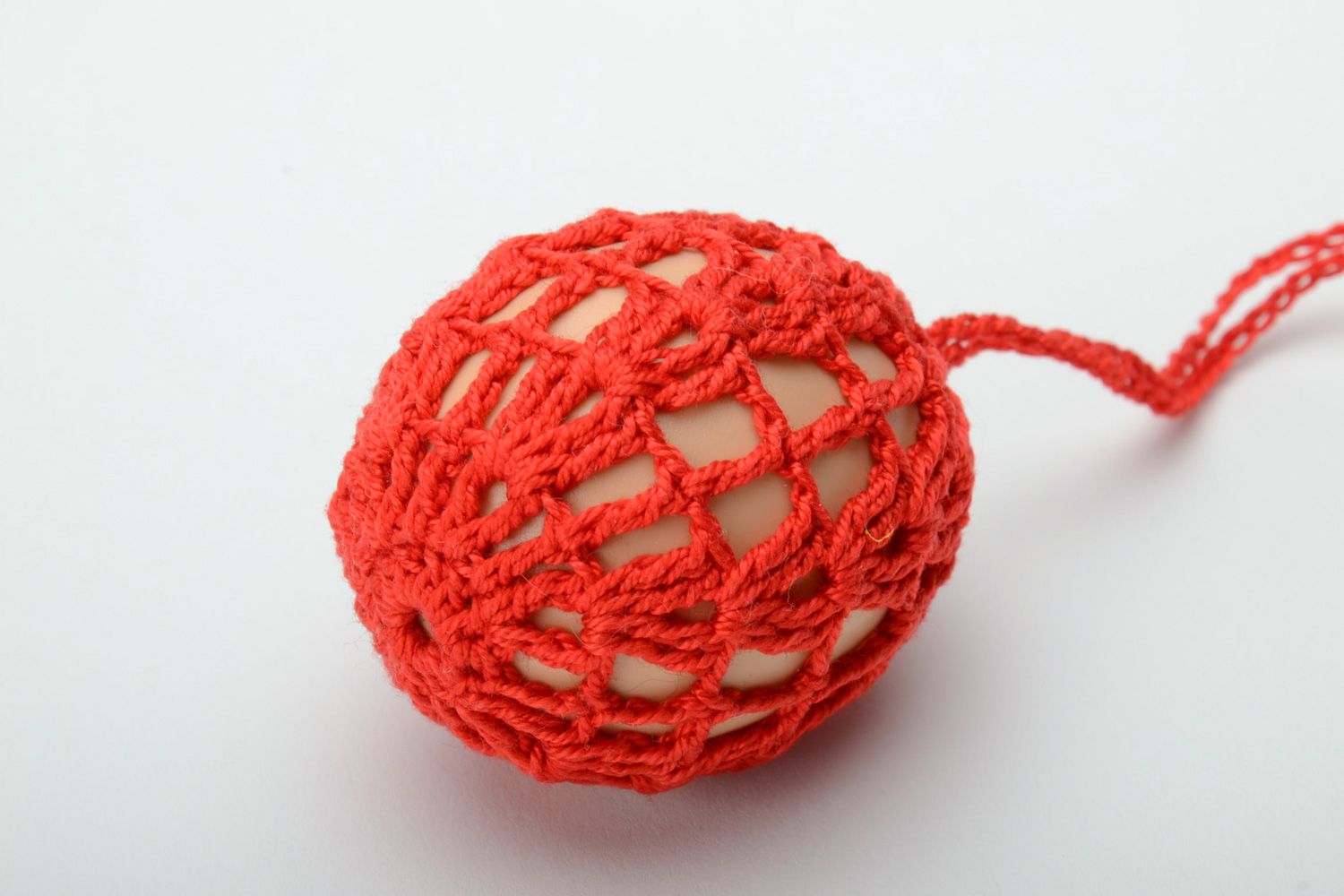 Homemade red decorative Easter egg woven over with threads photo 2
