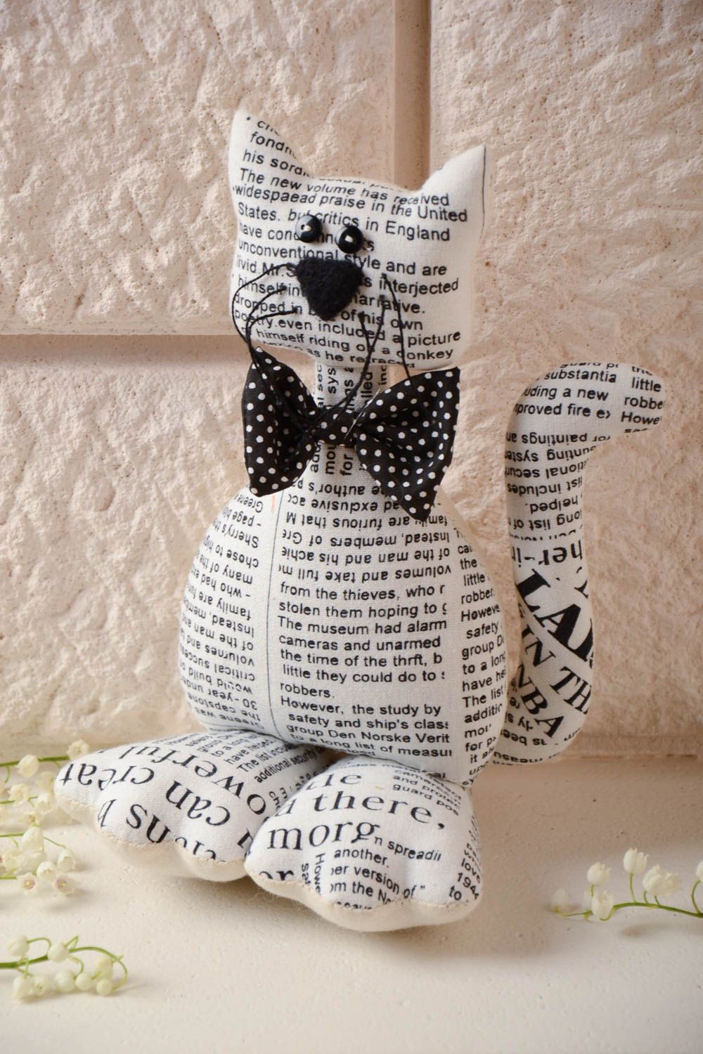 Handmade soft toy sewn of cotton with newspaper pattern Cat with black bow tie photo 1