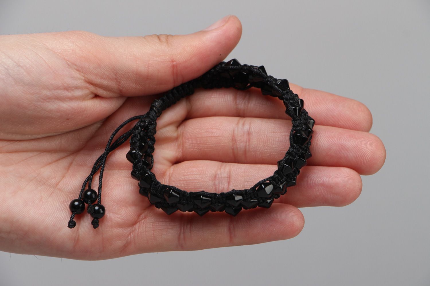 Handmade laconic friendship bracelet woven of black cord and beads for women photo 3