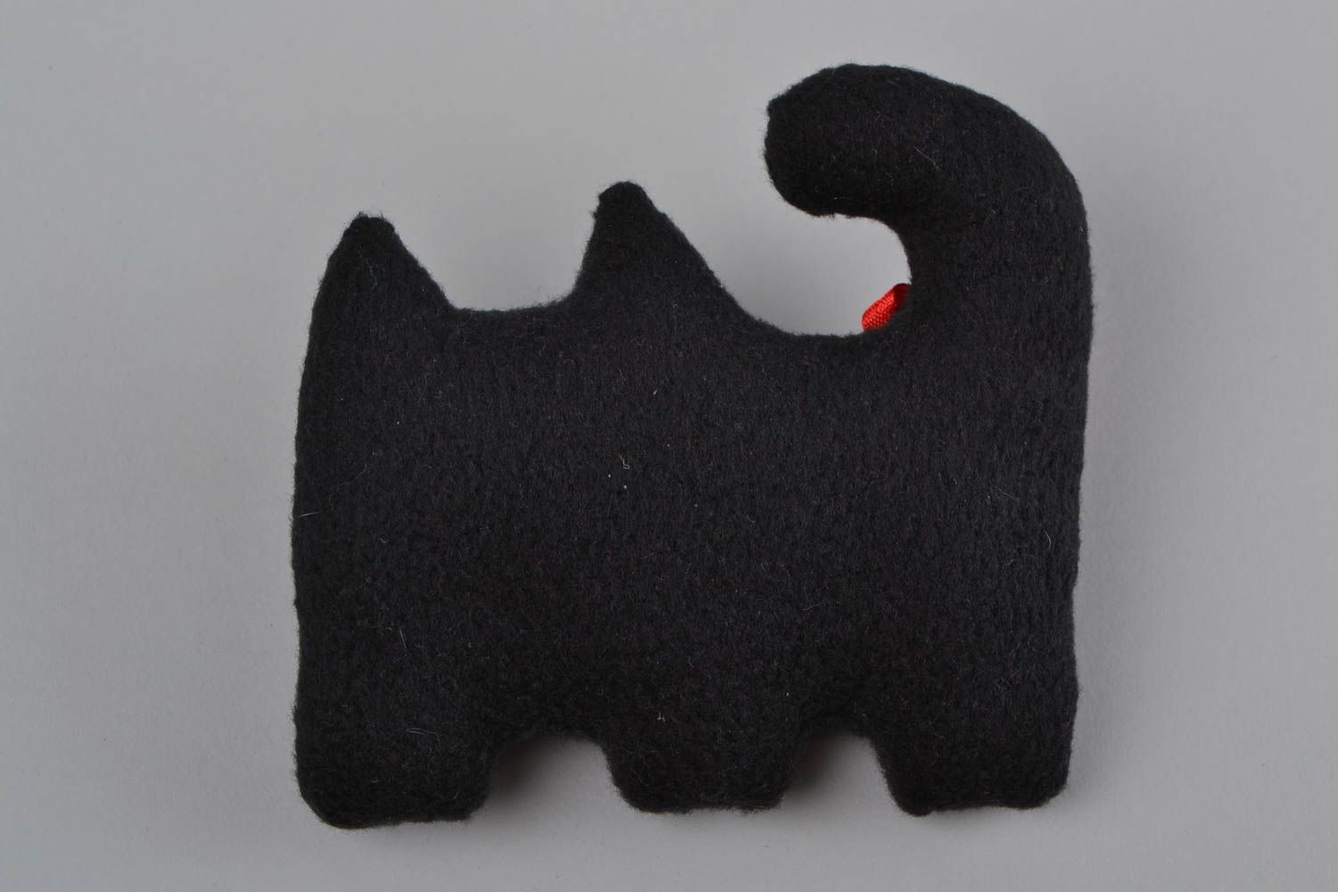 Handmade small soft toy sewn of black fleece in the shape of cat with red bow photo 5
