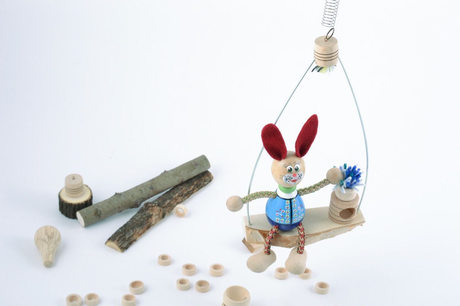 Handmade decorative painted eco friendly wooden toy of rabbit on swing  photo 2
