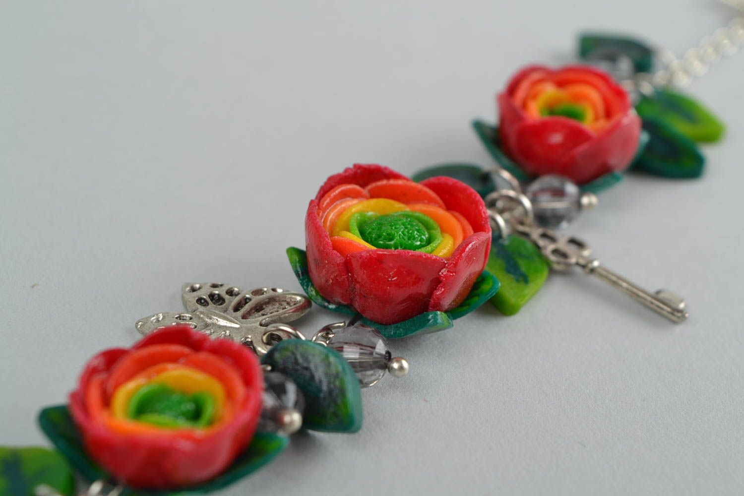 Beautiful women's handmade designer wrist bracelet with plastic flowers photo 5