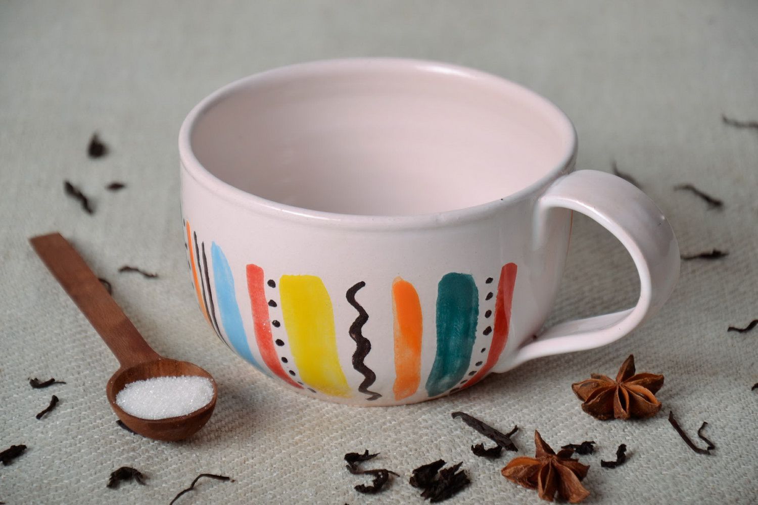 White glazed ceramic cup with handle in a color stripe pattern photo 1