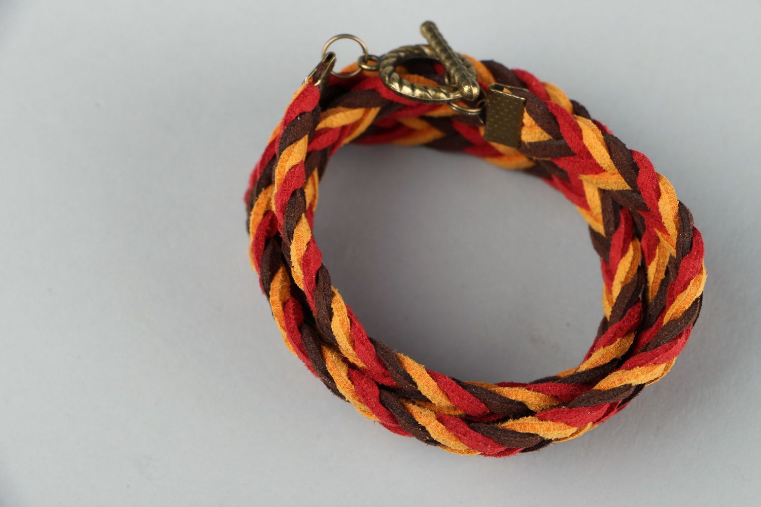Braided suede bracelet of red and brown colors photo 2
