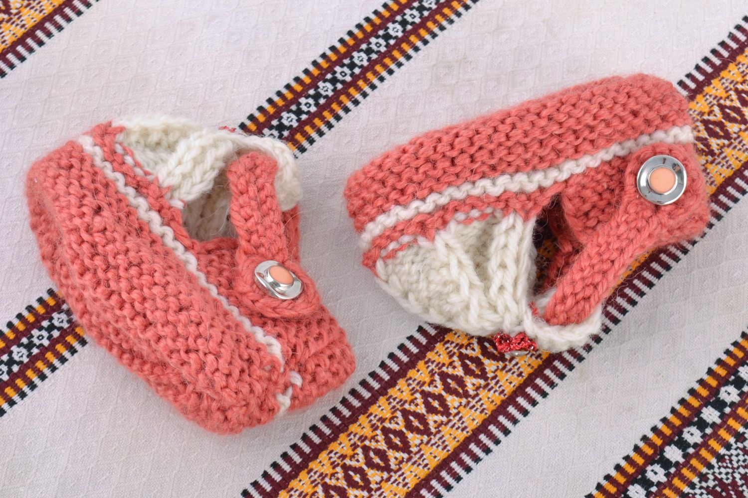 White and pink handmade knitted wool baby bootees for a girl photo 1