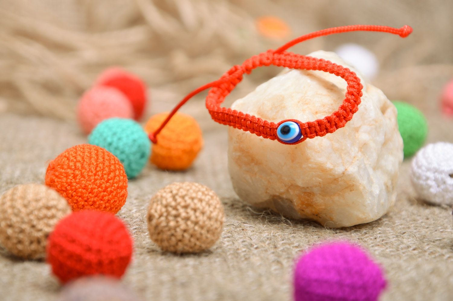 Braided handmade red wrist bracelet made of threads against the evil eye photo 1
