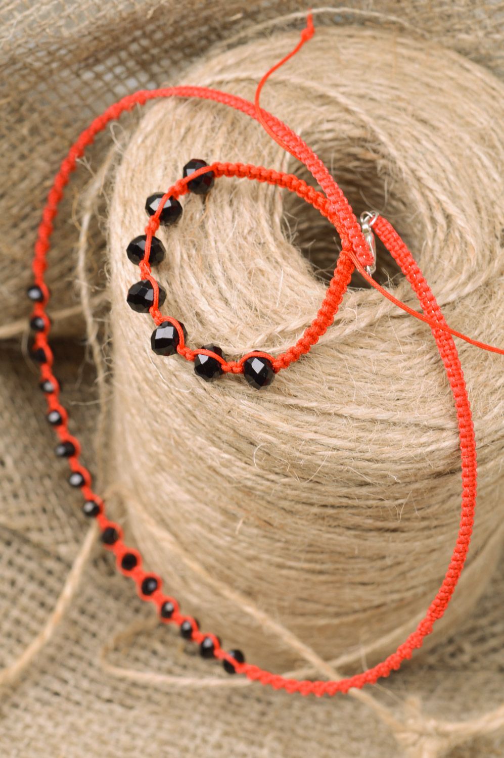 Handmade jewelry set woven of threads and beads 2 items necklace and bracelet of red color with black stones photo 1