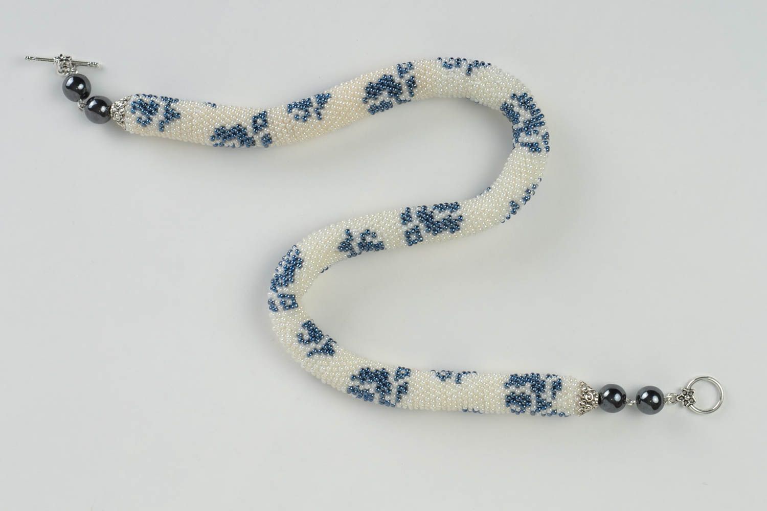 Beautiful handmade beaded cord necklace white with blue patterns photo 2