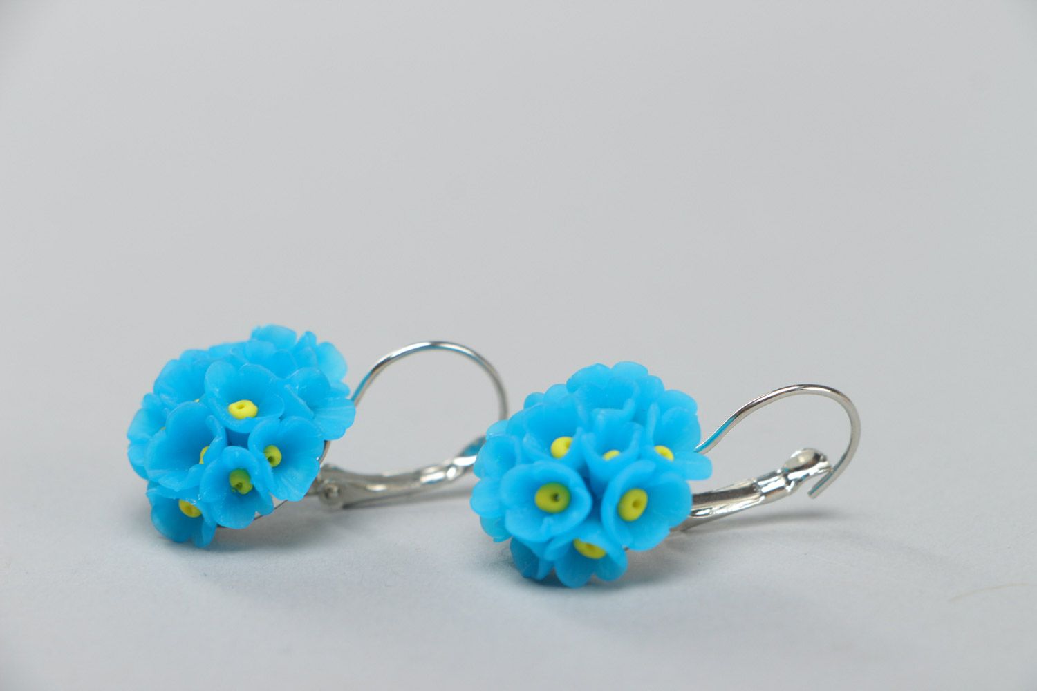Small handmade polymer clay dangling earrings in the shape of blue flowers photo 3