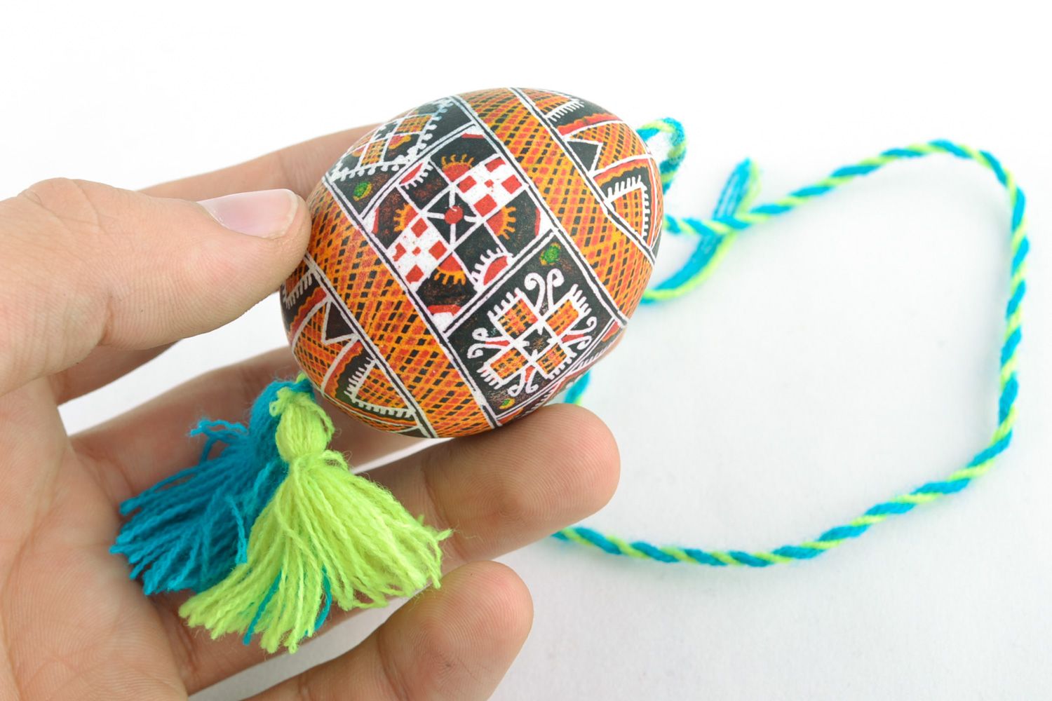 Handmade hanging Easter egg painted using wax technique with yellow and blue tassels photo 2