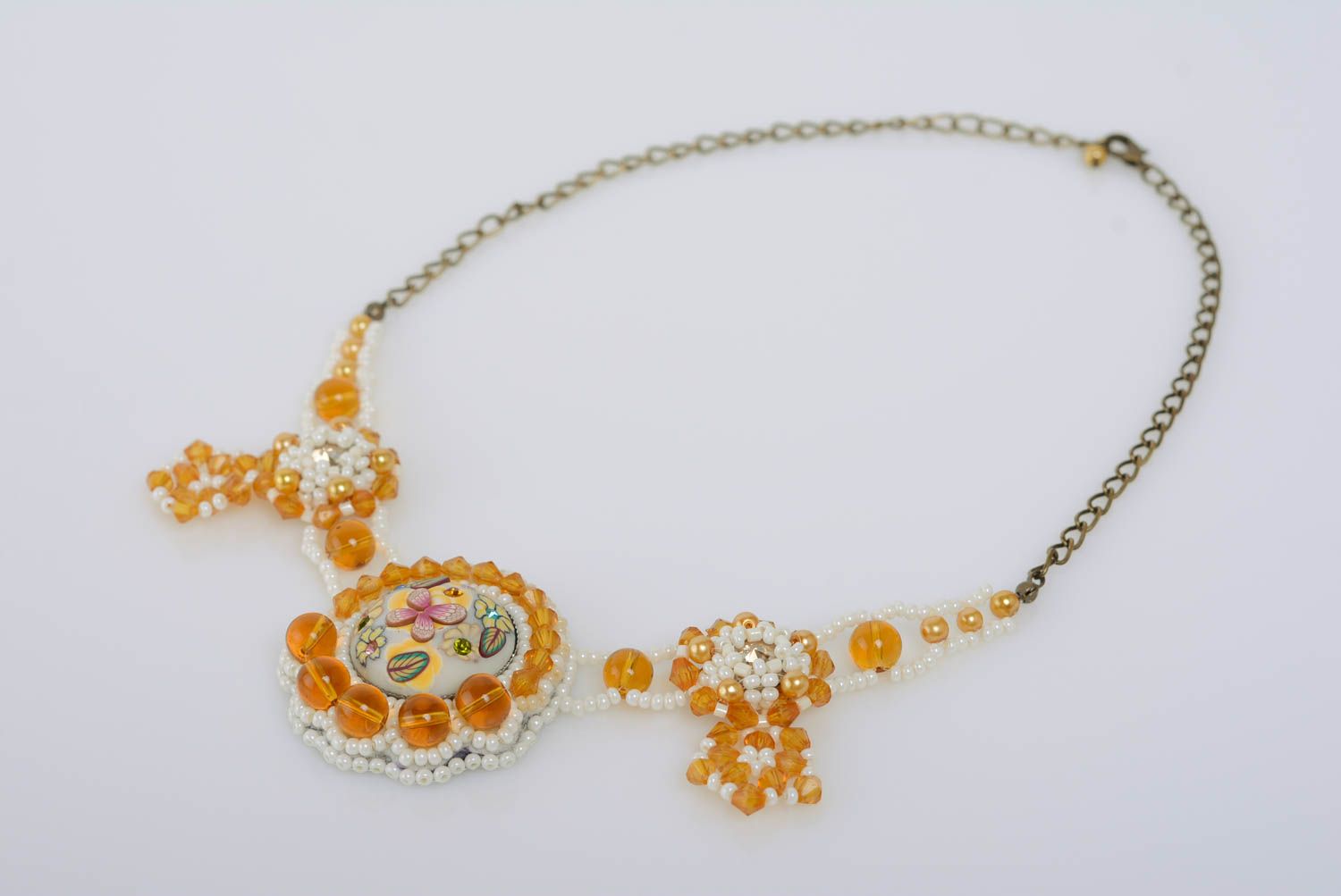 Handmade light bead embroidered white and yellow necklace on chain with crystals photo 1