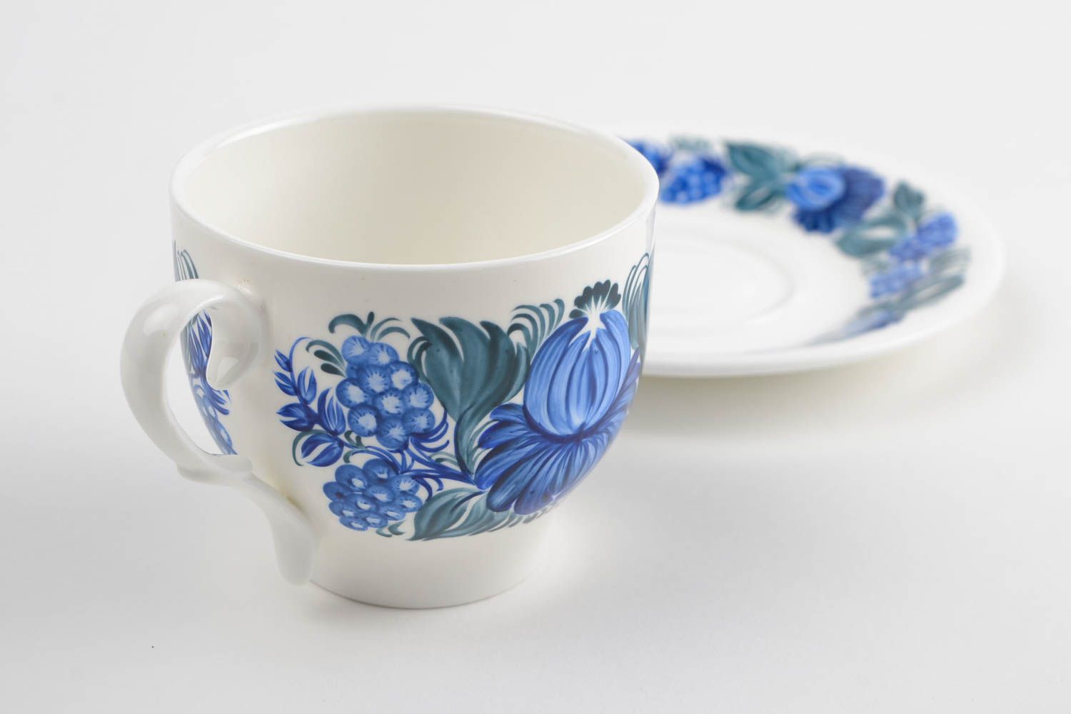 White porcelain cup with handle and saucer with blue floral pattern in Russian style photo 4