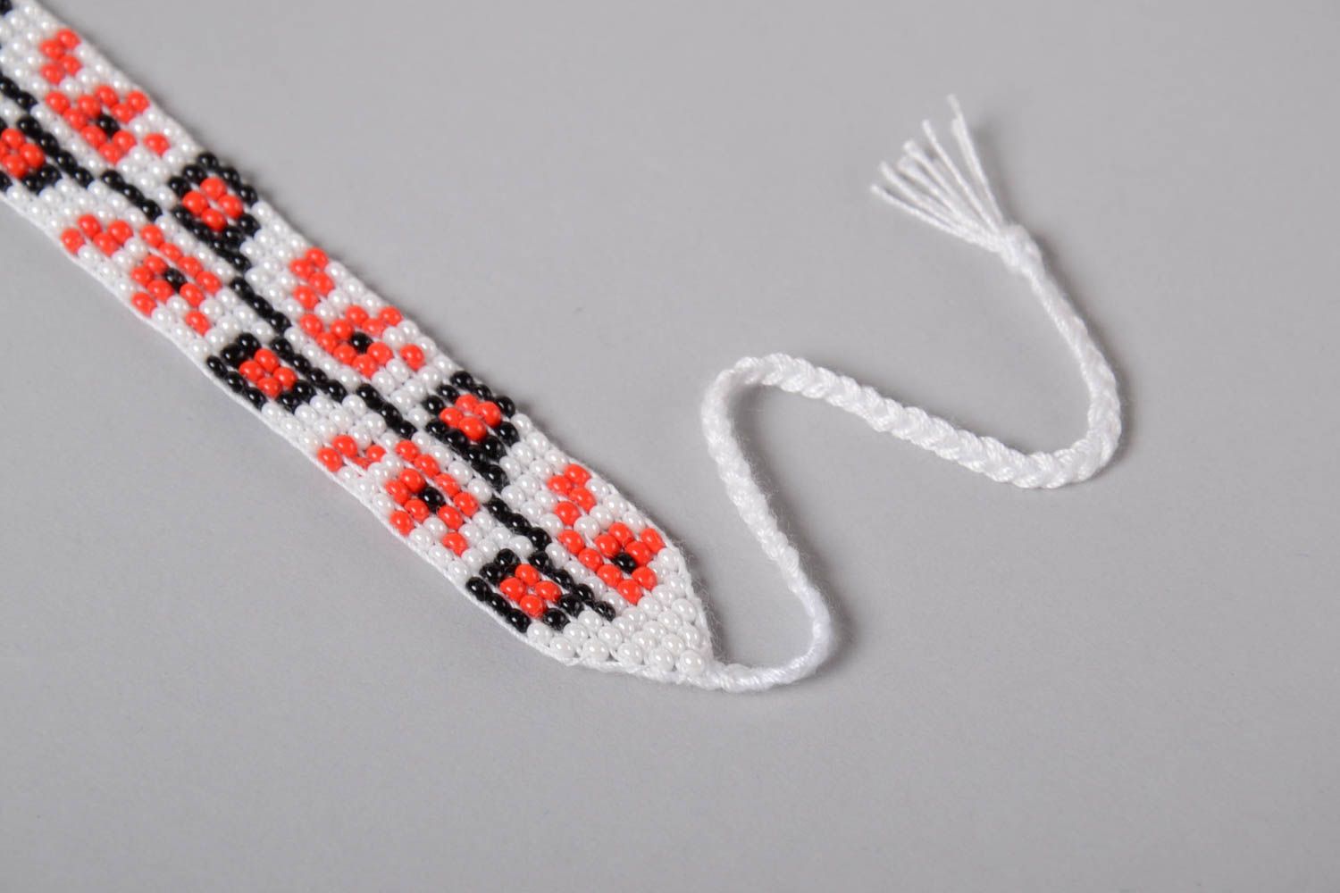 Handmade knitted beaded strand bracelet with Ukrainian ornament in red, black, and white color photo 4