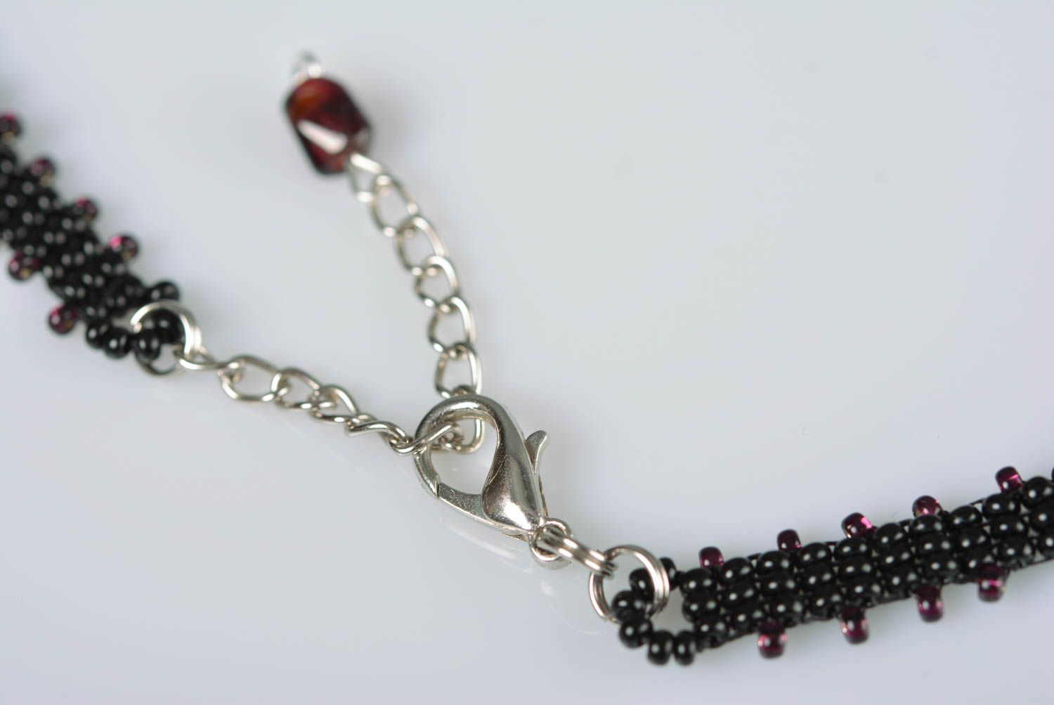 Beaded handmade necklace with lilac flowers on black background stylish jewelry photo 5