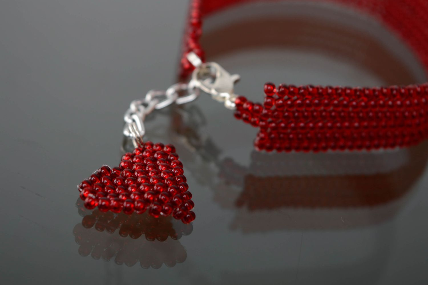 Red beaded bracelet with heart shaped charm photo 2