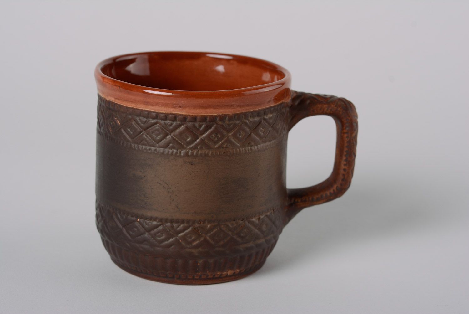 Rustic clay glazed cup with geometrical patterns and handle photo 1