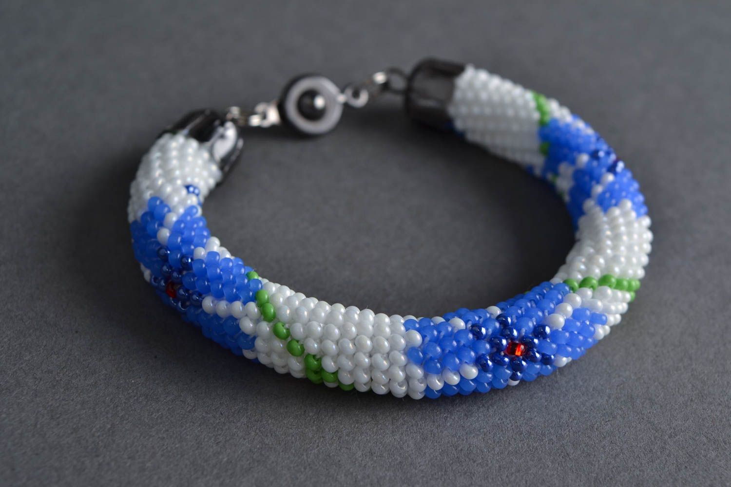 Handmade festive beautiful beaded cord bracelet white with blue flowers photo 1