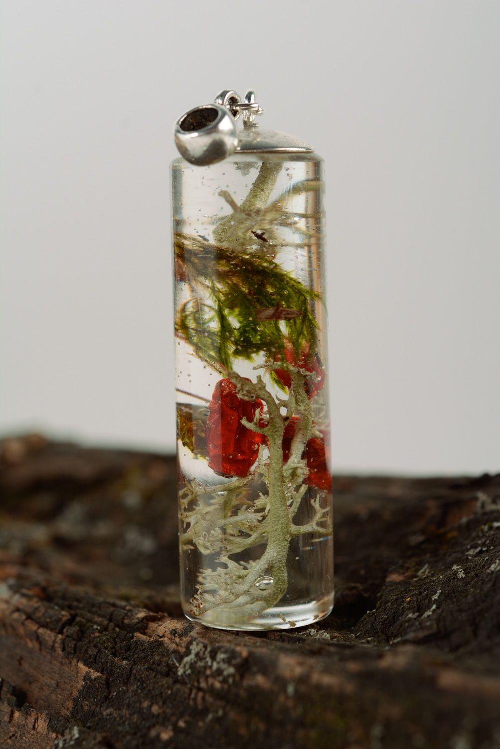 Transparent handmade neck pendant with berries coated with epoxy resin photo 1