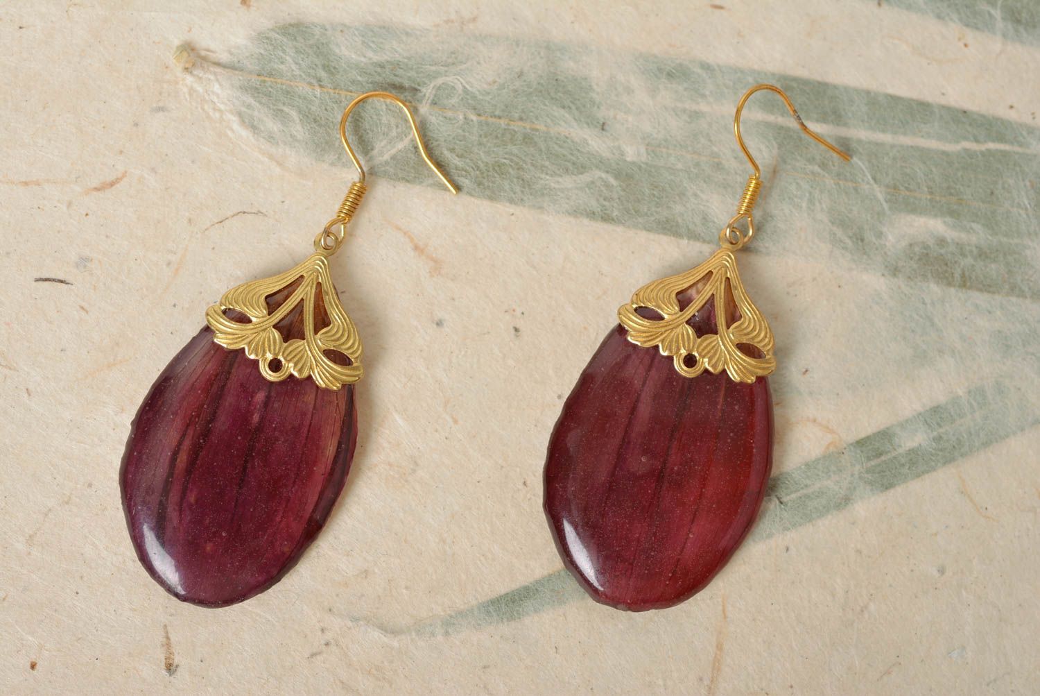 Handmade designer earrings with dark purple flower petals in epoxy resin photo 1