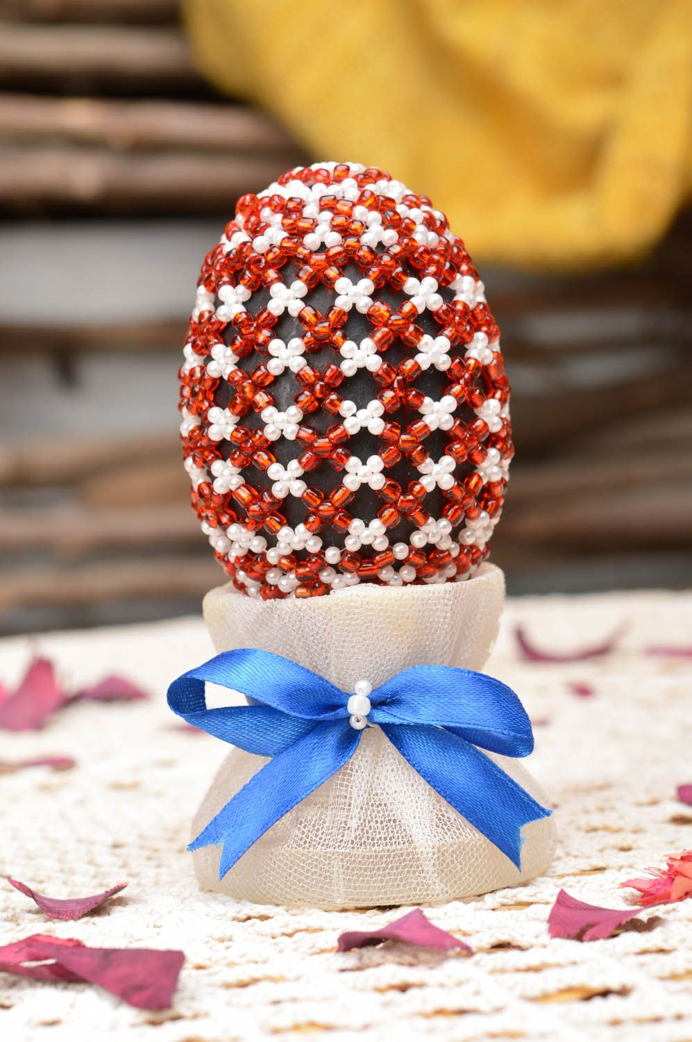Red and white handmade papier mache egg woven over with beads on holder photo 1
