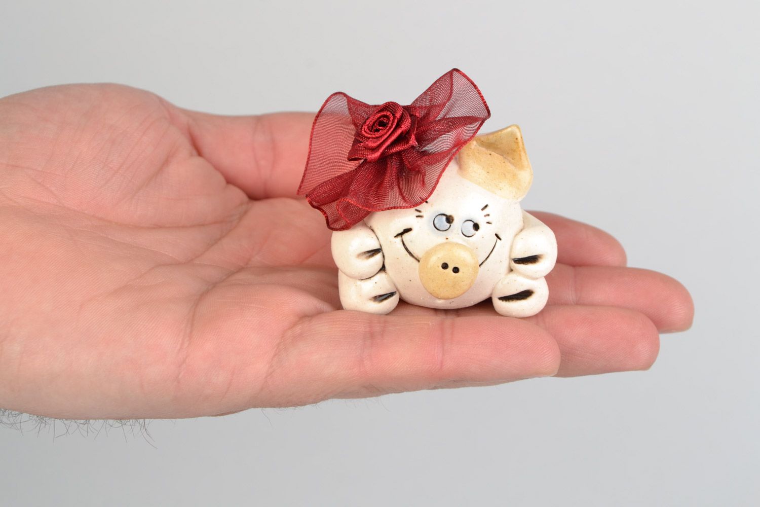 Funny small handmade porcelain statuette of pig with bow for decor photo 2