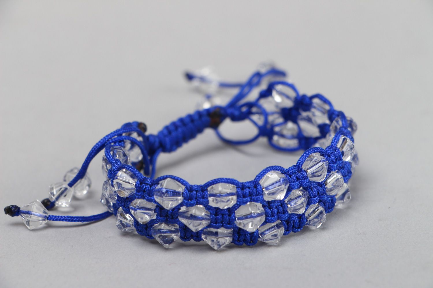 Handmade blue friendship bracelet with synthetic thread and faceted glass beads photo 1