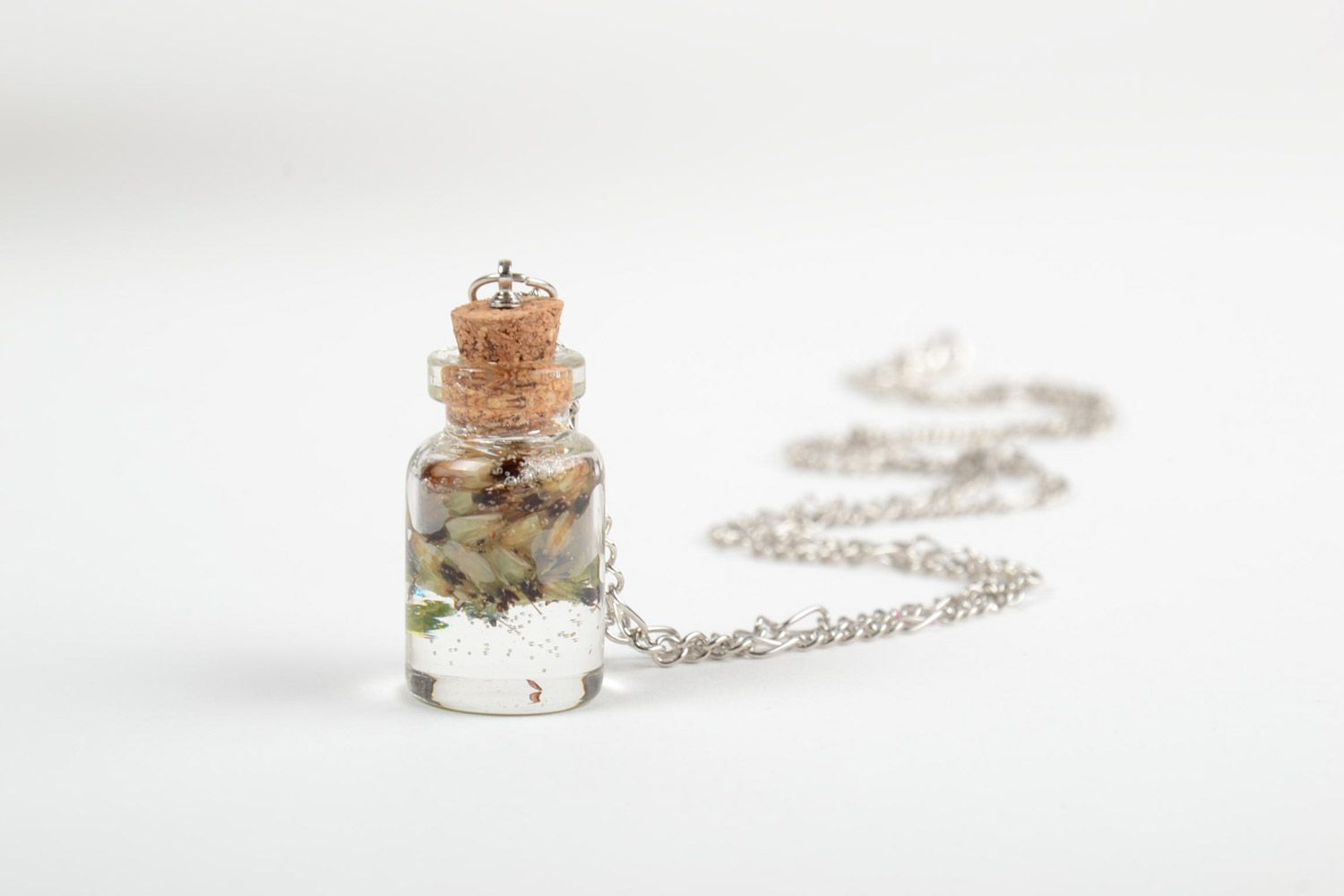 Handmade neck pendant with real flowers coated with epoxy in the shape of transparent vial photo 4