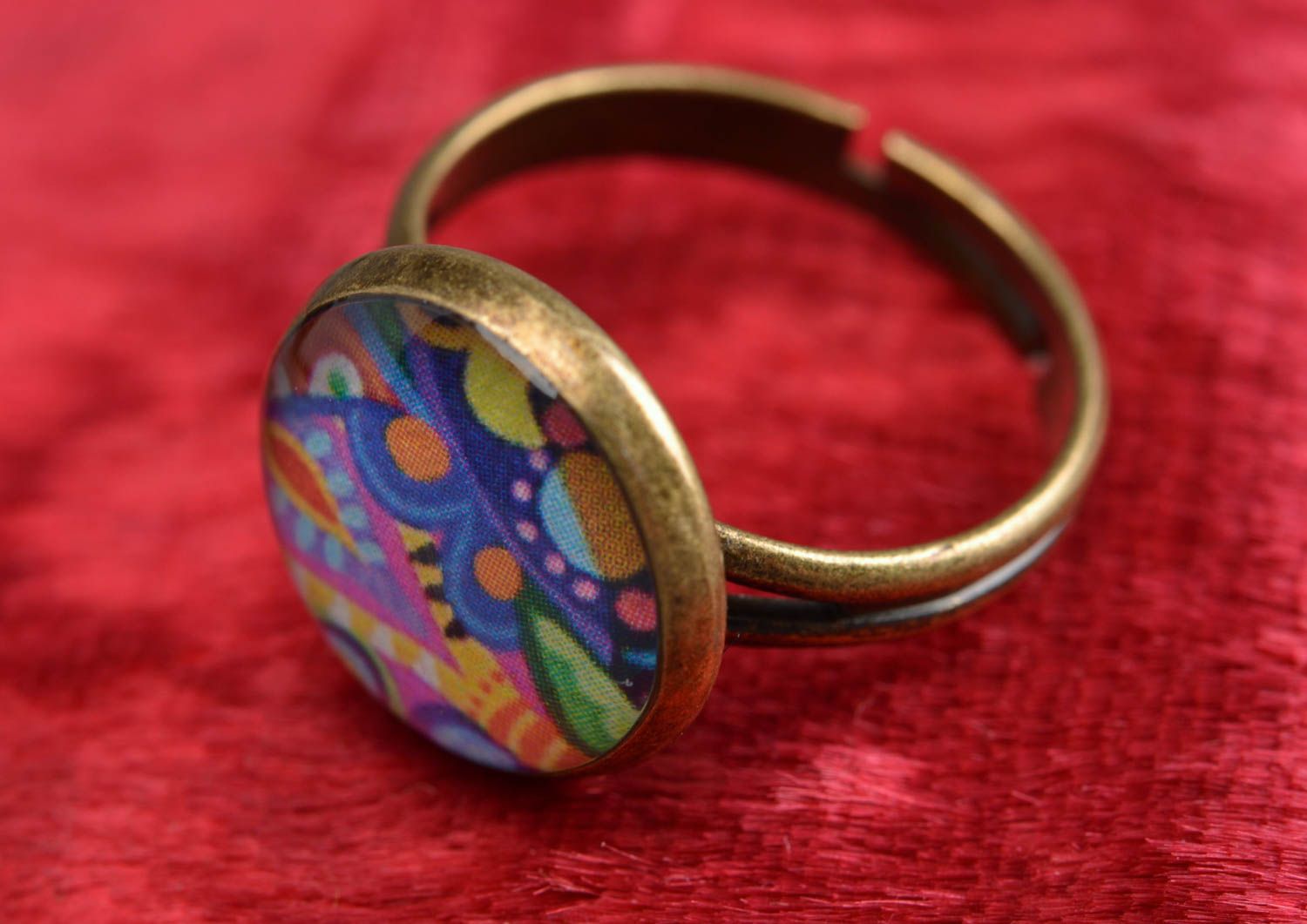Handmade decoupage jewelry ring in epoxy resin with bright pattern on metal basis photo 1