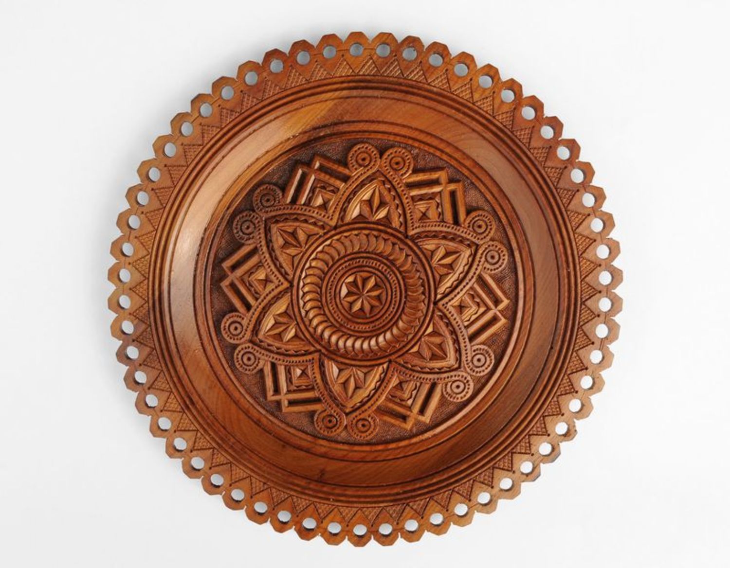 Wooden plate with carvings photo 1