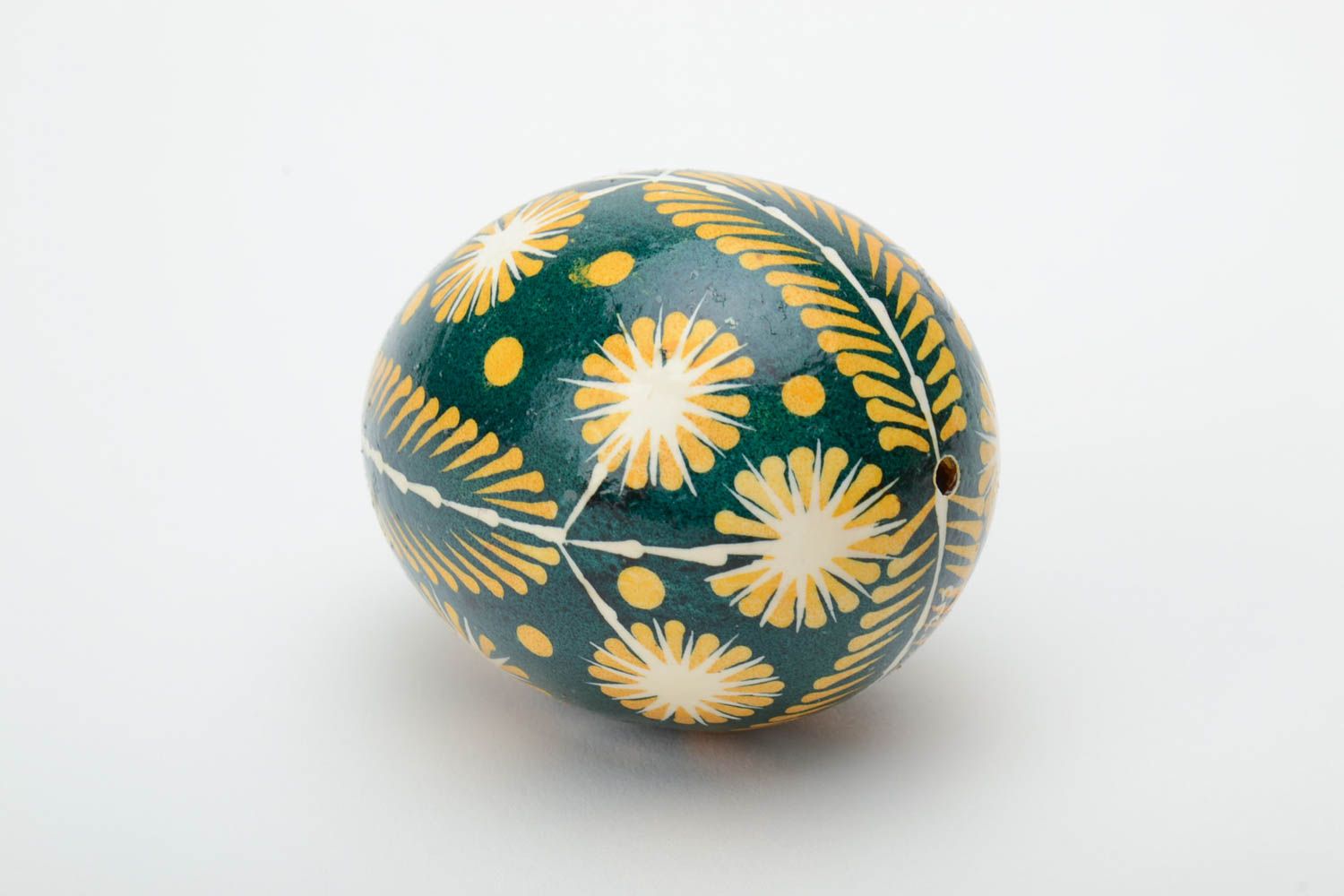 Green and yellow handmade painted Easter egg ornamented using waxing technique photo 4