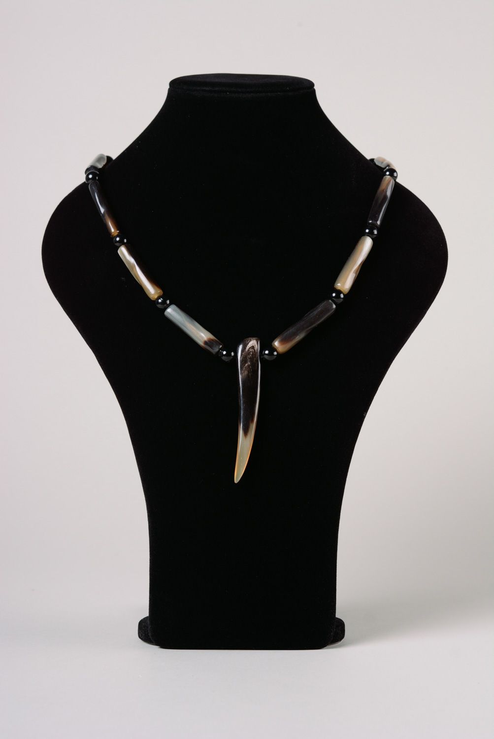 Handmade women's cow horn necklace in gray color palette in ethnic style photo 1