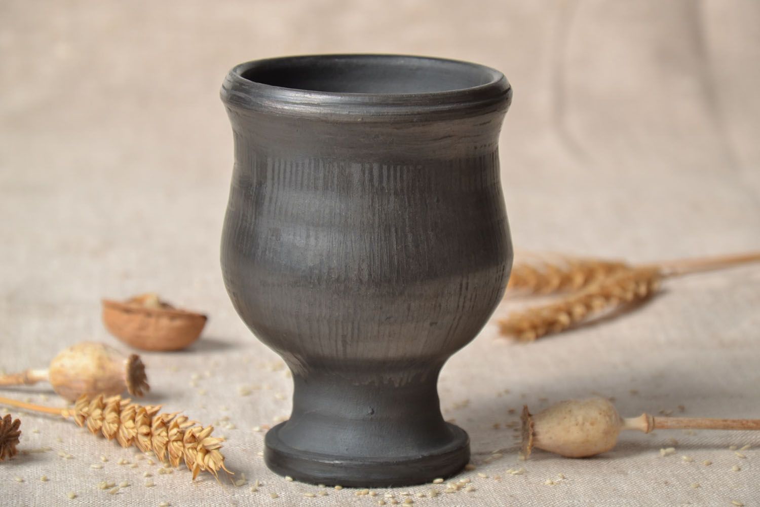 Wine goblet in black color on the stand without a handle. Great natural clay gift. photo 1