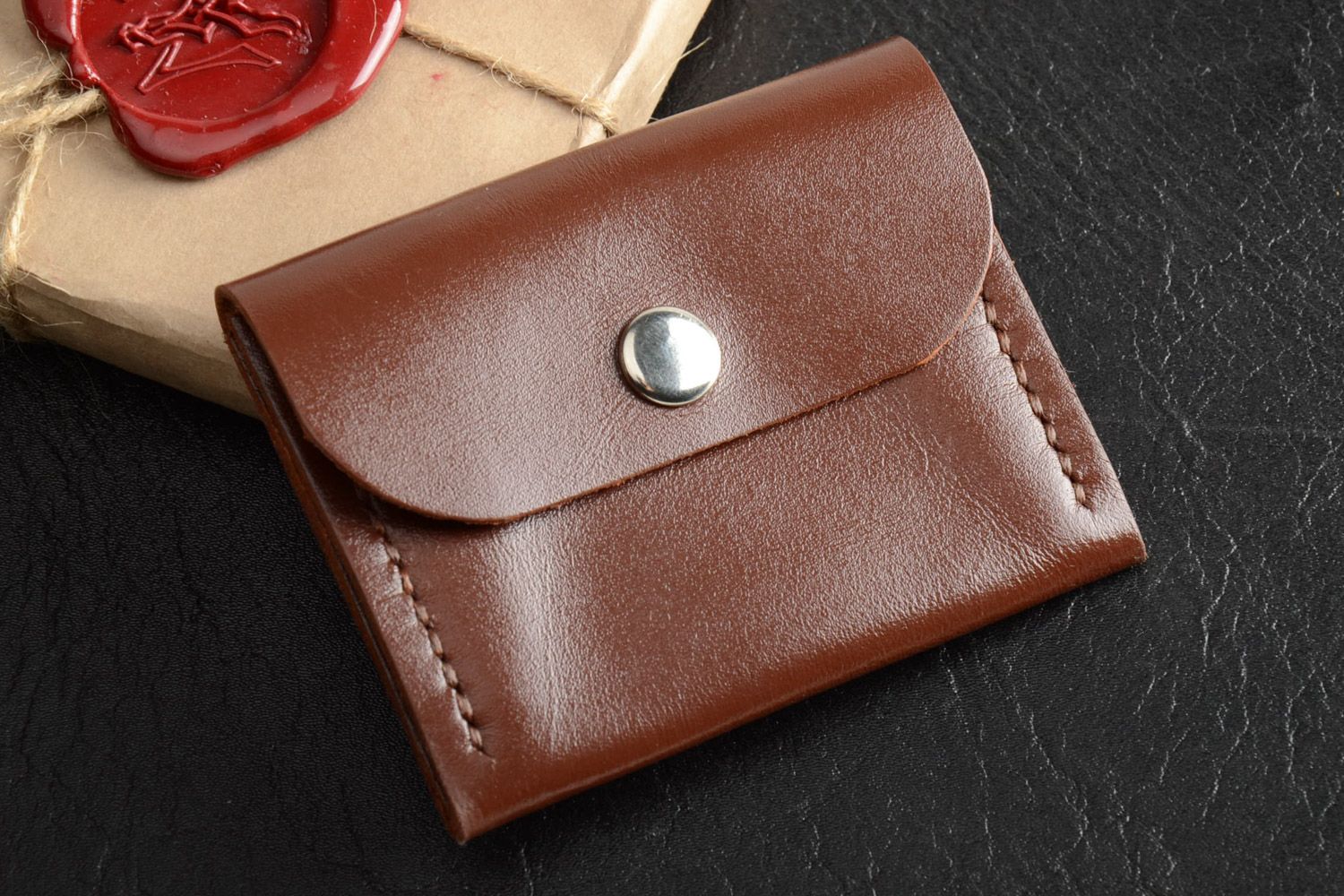 Handmade men's coin purse sewn of genuine leather of brown color with metal stud photo 1