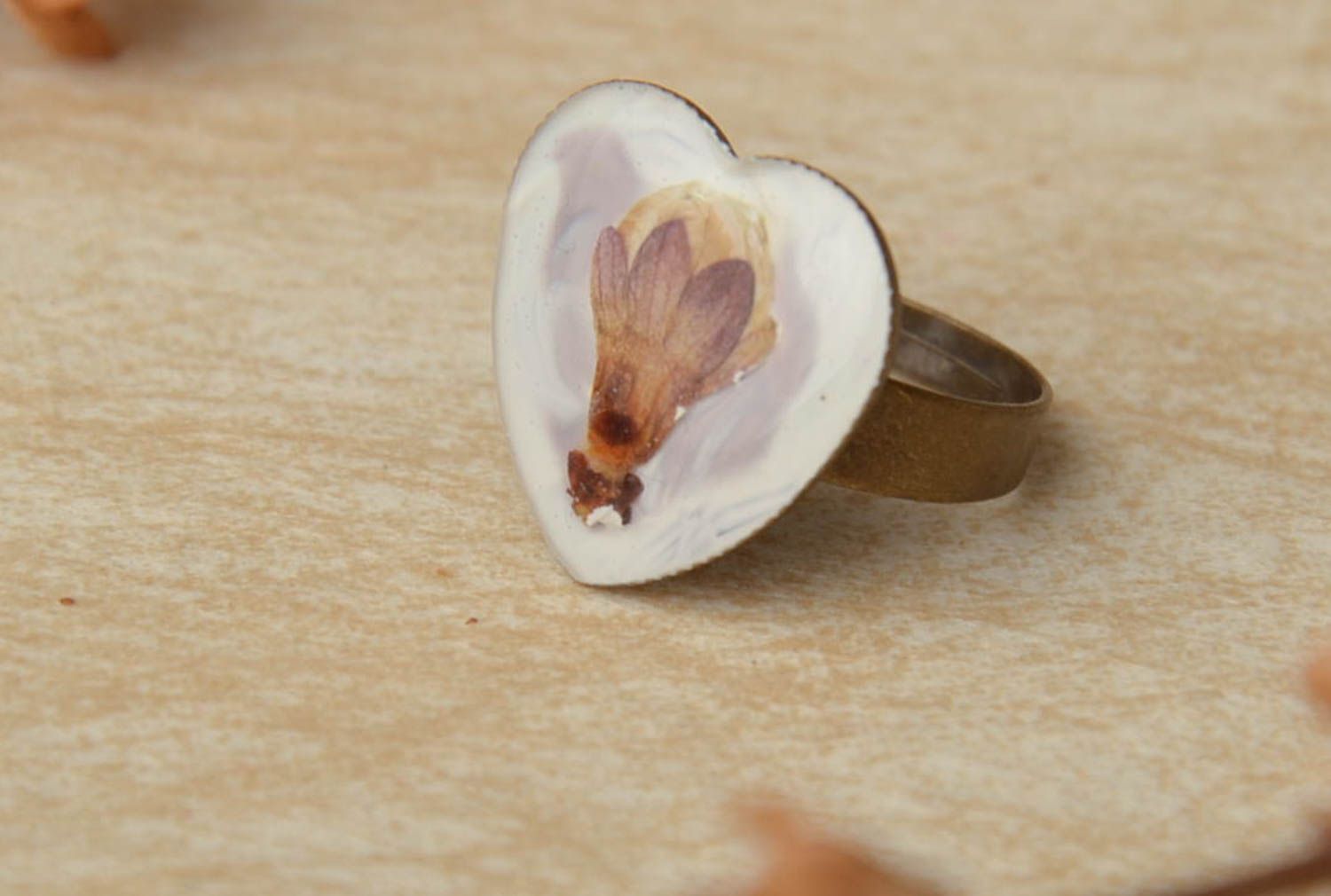 White ring with natural flower in epoxy resin photo 1