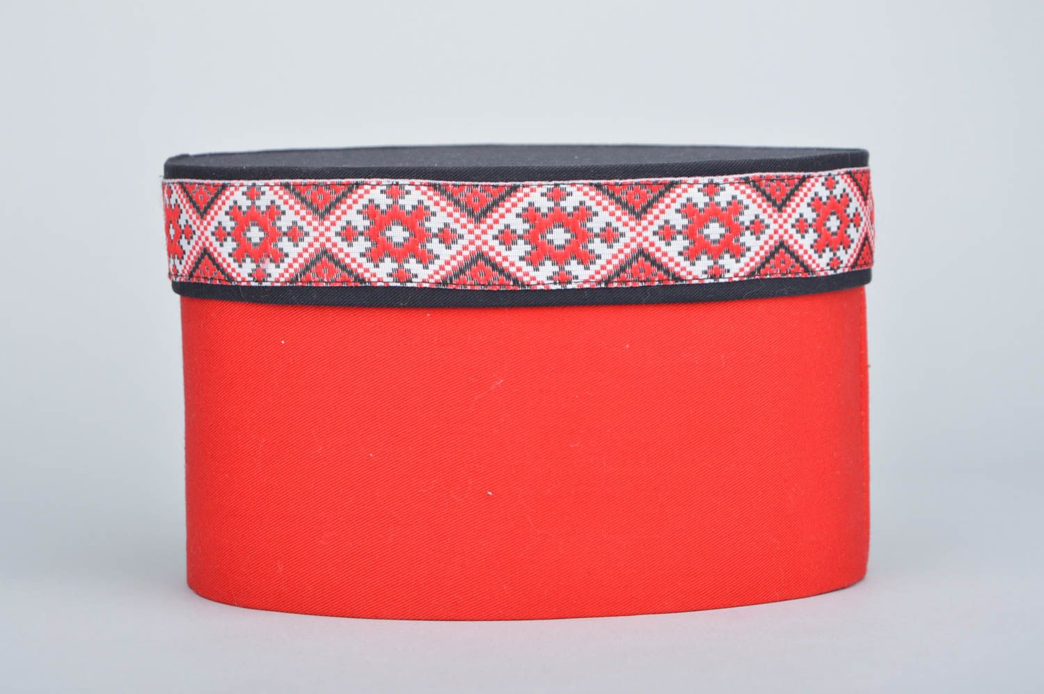 Handmade decorative oval carton box covered with red fabric with ethnic motifs photo 2