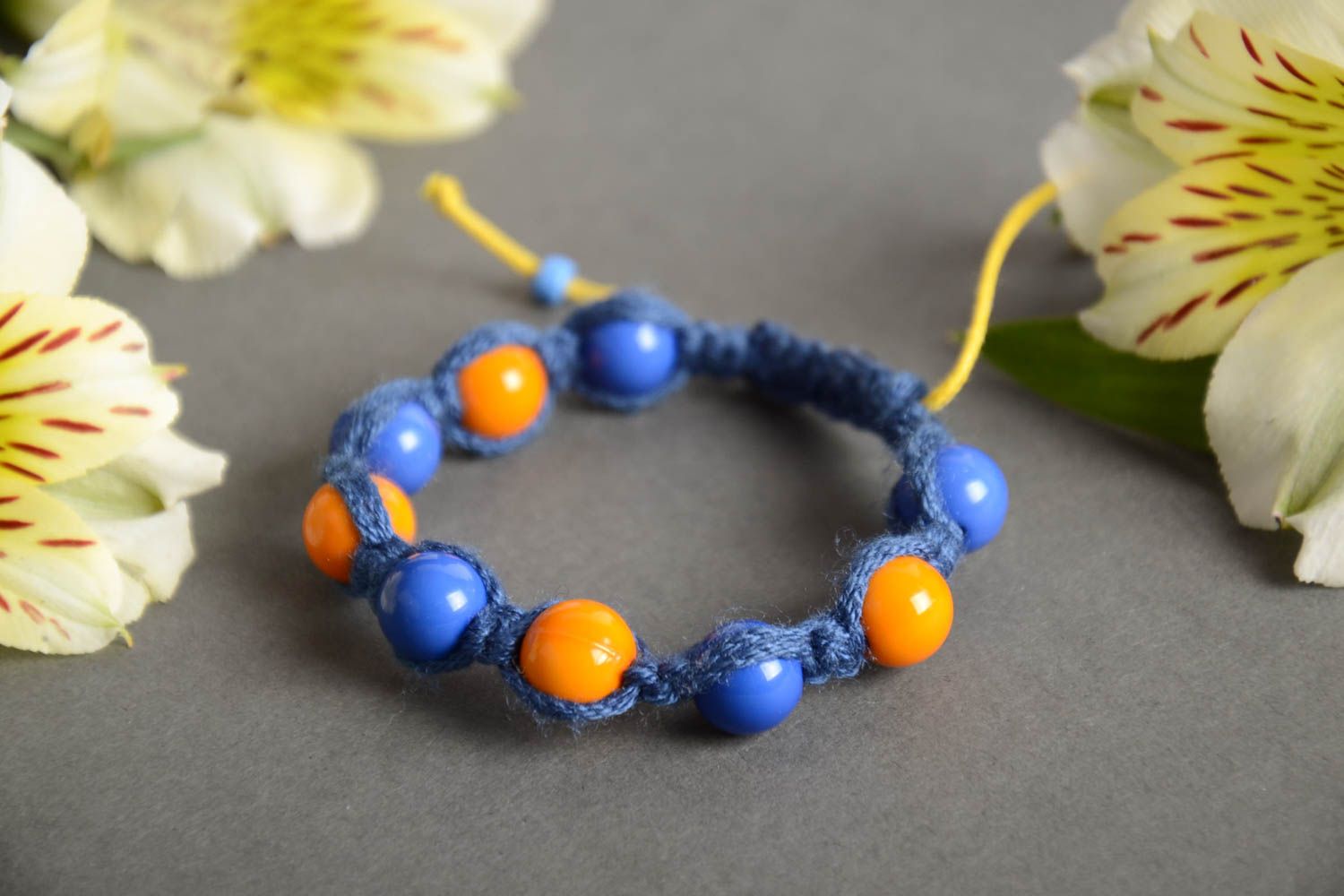 Handmade friendship bracelet woven of blue cord and orange beads for children photo 1