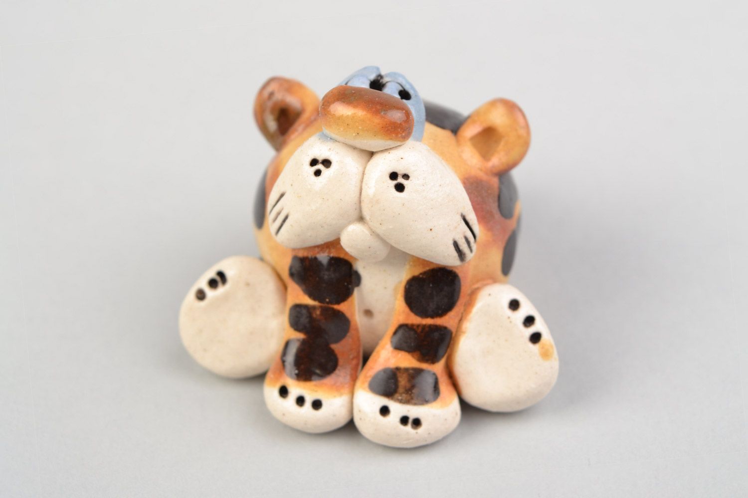 Handmade funny ceramic figurine of colorful sitting tiger painted with glazes photo 1